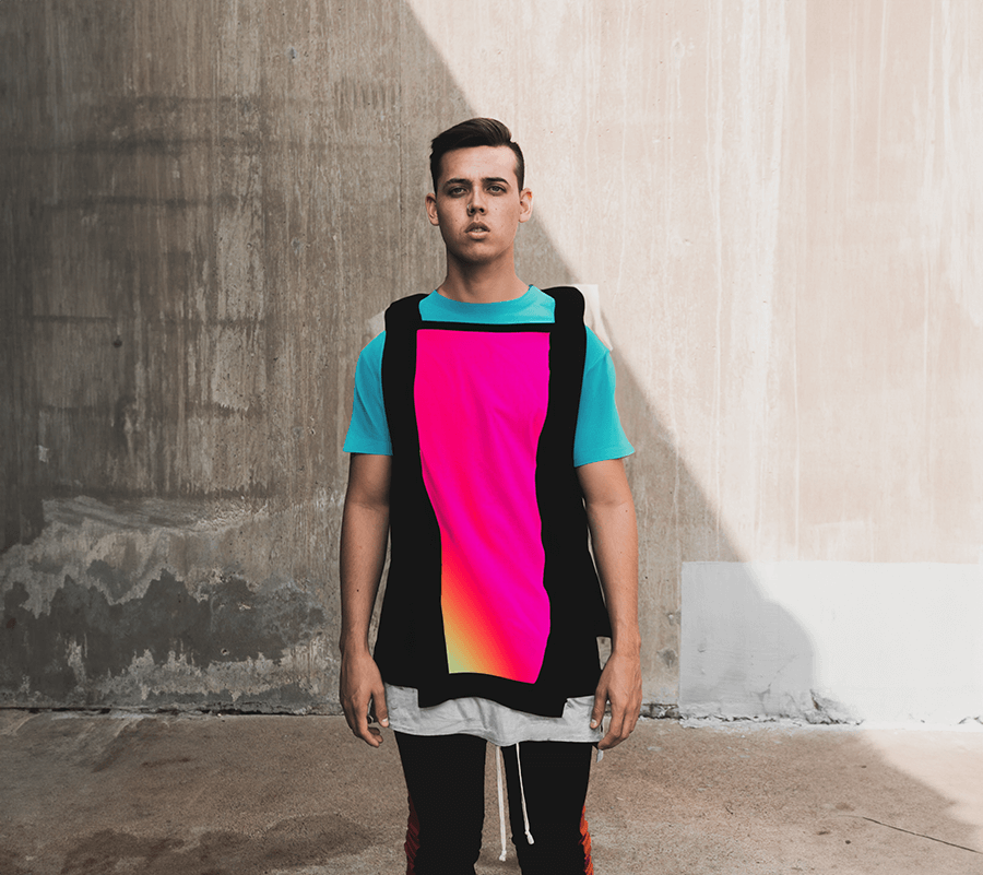 Male model standing up straight wearing bright neon tee-shirt